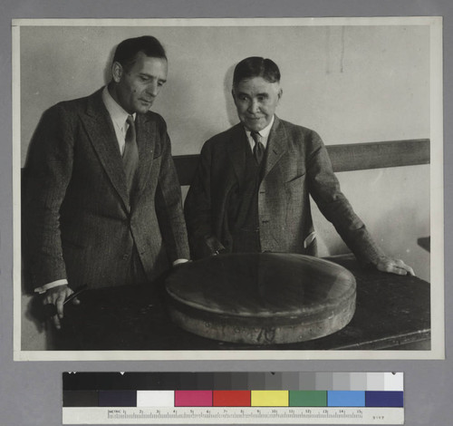 Edwin Powell Hubble and Edward Curtis Franklin viewing fused quartz mirror for telescopes