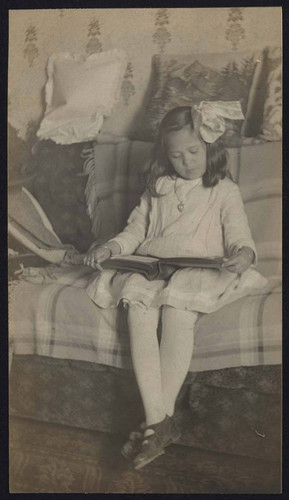 Young girl looking at photo album