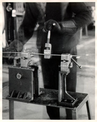 [Worker making cable wire for the San Francisco-Oakland Bay Bridge]