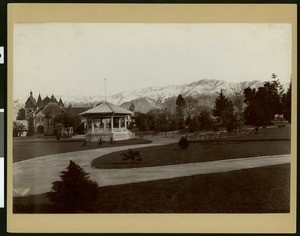 Exterior view of the Pasadena Public Library with a park in the foreground, 1907