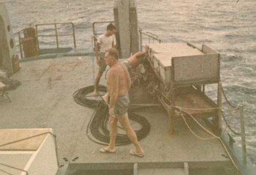 George W. Hohnhaus (foreground) on R/V Horizon, putting the magnetometer fish into the water and paying out endless cable. Nova Expedition, 1967