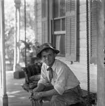 Young man posing on porch