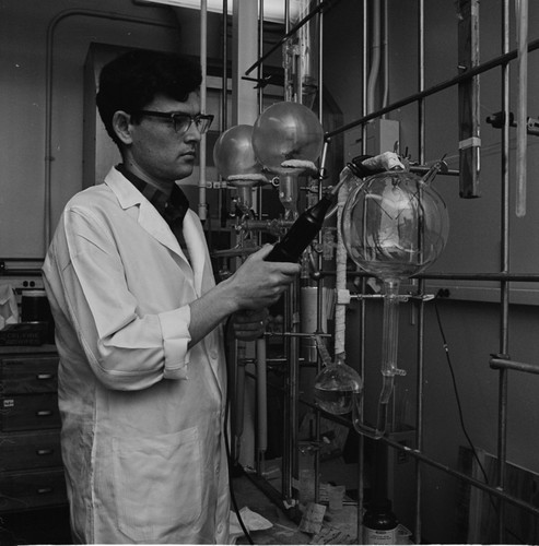 Unidentified man shown here working with scientific equipment in what was Stanley Miller's laboratory at UCSD. Miller was a renowned chemist and biologist who known for his studies into the origin of life. February 25, 1970