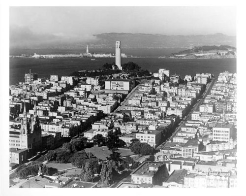 [Aerial view of Coit Tower and surrounding area with World's Fair of 1939 in background]