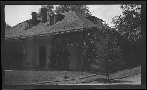 Cottage with ivy and rocking chair (unidentified), California