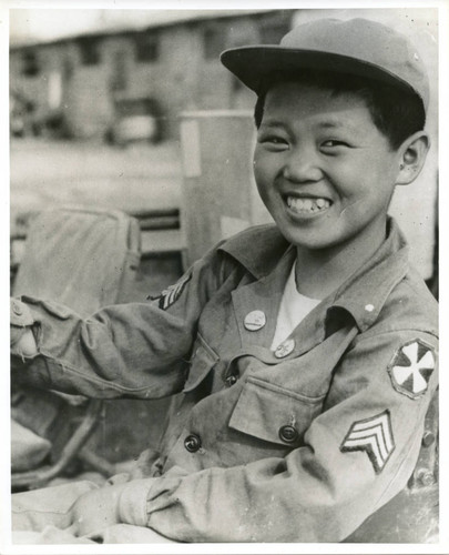 Portrait of boy wearing Army jacket