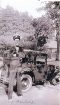Mill Valley Fireman posing beside his squad car, circa 1919