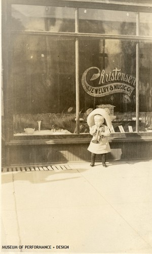 Lew Christensen as a toddler playing a trumpet