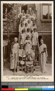 Young girls standing on a wooden stair with their instructors, Satara, India, ca.1920-1940
