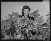 Marguerite Clark amongst the flowers in The Times building, Los Angeles, 1936