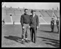 Football player Red Grange and manager C.C. Pyle posing, Los Angeles Coliseum, Los Angeles, 1926