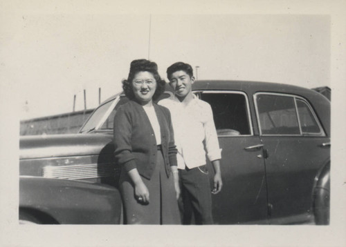 Man, woman, and car at Poston incarceration camp