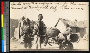 Refugees pushing a laden cart, Haizhou, Jiangsu, China, ca.1914-1915