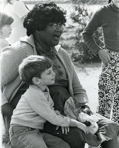 Student teacher with children outdoors, mid 1970s