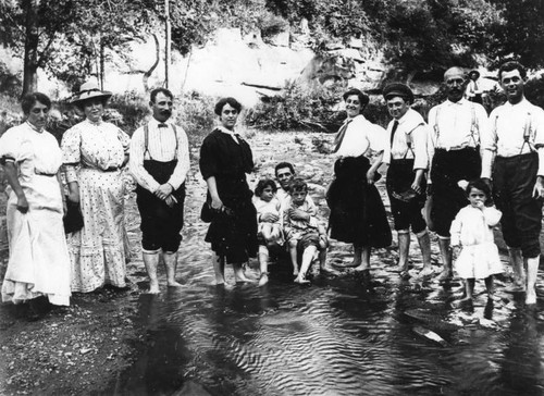 Family wading in stream