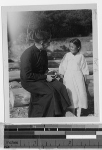 Fr. Carroll, MM, talking to Denise Ni, Masan, Korea, ca. 1920-1940