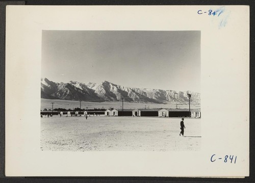 Manzanar, Calif.--View of barracks at this War Relocation Authority Center, looking southwest across the wide fire-break which is used as a recreation field. Photographer: Lange, Dorothea Manzanar, California