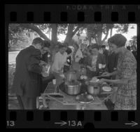 Group of people serving tea and rice during interfaith "Fast for Peace" at Whittier Central Park, Calif., 1967
