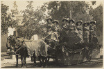 [Women on horse-drawn parade float in Bishop]