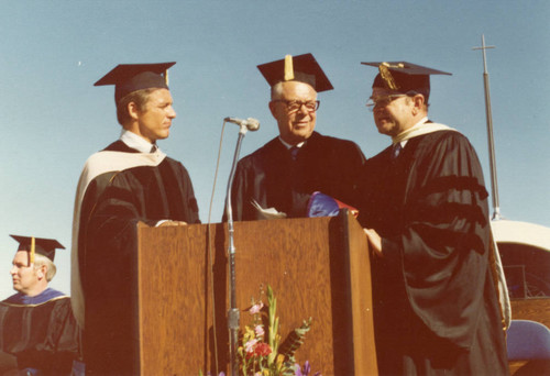 Chancellor Young and President Banowsky awarding an honoray doctorate to Honoree #1