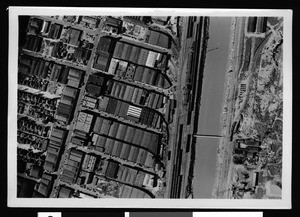 Aerial view of a flooded area, showing closely-spaced buildings, 1938