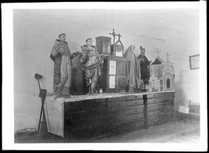 Mission San Gabriel sacristy, showing statues of saints, ca.1900