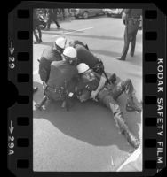 Police restraining Iranian man at clash between Pro-Iranian and Anti-Iranian demonstrators in Los Angeles, 1979