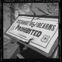Forest service "Discharge of Firearms Prohibited" sign damaged by shotgun blast, Calif., 1965