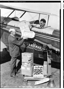 Inauguration of the Air Express Service, showing Woods handing letters to pilot, August 31, 1927
