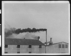Unidentified factory exterior, showing roof and smokestacks, ca.1940