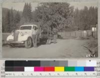 G. Gill of Contra Costa County and his truck loaded with lumber sawn at portable mill, Whitaker's Forest, and poles and slabs. He hauled the material 225 miles and the total cost to him was about $27.00 per M. 1938. Metcalf