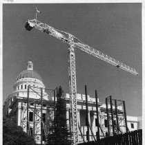 View of the California State Capitol building surrounded by steel supports and scaffolding. The steel work will help hold up the walls while the interior is torn out for restoration