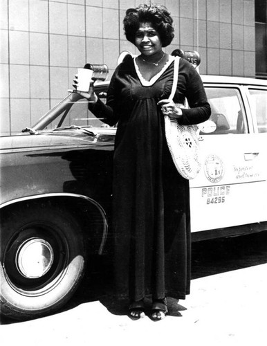 Woman in front of police car
