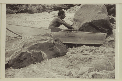 Norm Nevills in 13-Foot Rapid, San Juan River. The flow is less than 400 cfs. The boat is a 10 ft. folding spruce boat owned by Ansel Hall