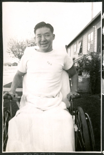 Photograph of Peter Hondo in a wheelchair at Manzanar