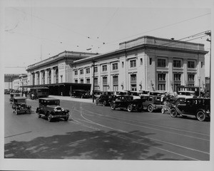 Shot of the Southern Pacific Station with many cars parked in front of it, 1930