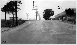 Fremont Avenue crossing of Southern Pacific Ry., Alhambra, from south side of S.P.Ry. looking north showing abrupt jump and top of steep approach grade on left side of road, Los Angeles County, 1928