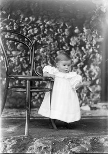 Little child next to a chair, Tanzania, ca.1893-1920