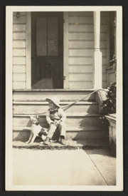 Child sitting next to dog