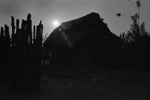 Fence and house at sunset, San Basilio de Palenque, ca. 1978