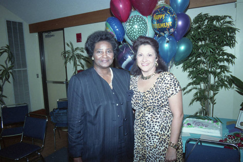 Estella (Bobbe) Akalonu posing with a women during her retirement party, Los Angeles, 1993