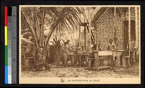 Men working outdoors by a brick building, Congo, ca.1920-1940