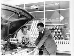 Art Lindberg and John Smath looking under the hood of a car at Smitty's Shell Service, Santa Rosa, California, 1966