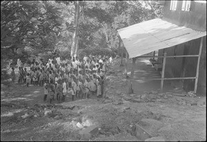 Pupils waiting in front of their school