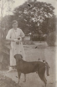 A missionary woman with animals : Blackie, the old dog and three cats