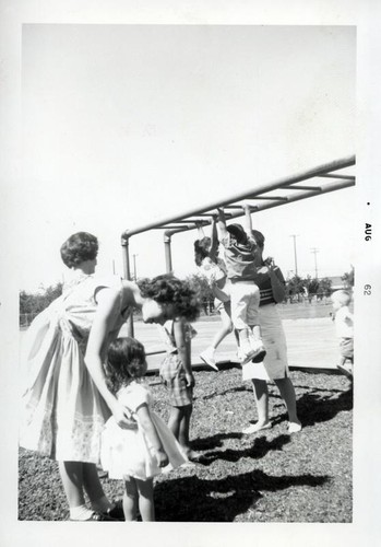 Group of small children playing on the monkey bars