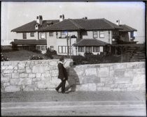 Man walking in front of grand house