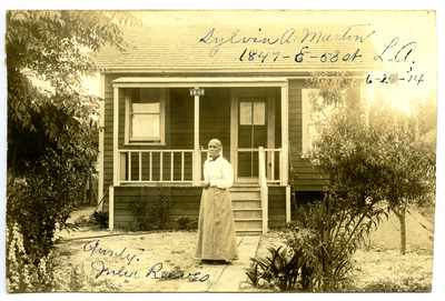 Julia Reeves [?] standing in front of house of Sylvia A. Martin, 1845 E. 53 St., Los Angeles, California