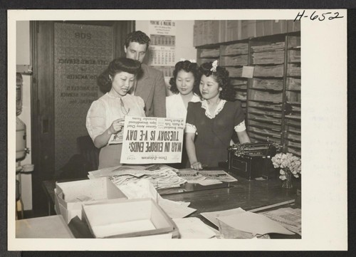 Mary Kitano from Manzanar works for City New Service in Los Angeles. Holding the paper is Betty Lyou, Korean; next