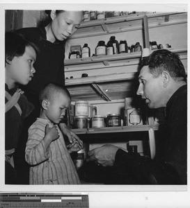 Fr. Mihelko at the dispensary at Wuzhou, China, 1950